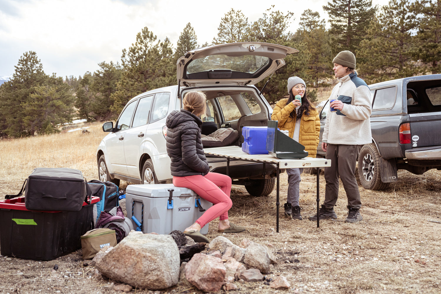 People enjoying the Hele Box car camping platform when in table mode