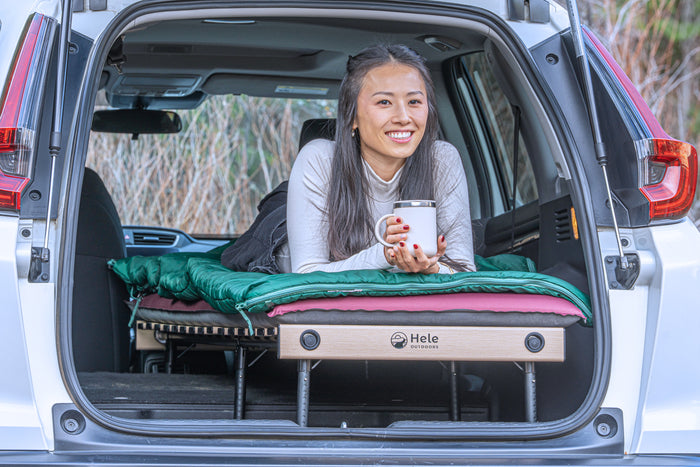 Girl sitting on Hele Box Car Camping Platform 